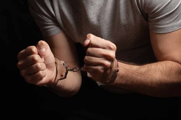 istock Man, criminal and handcuffs for interrogation, crime or money laundering in arrest on table in room. 2015283276