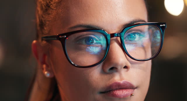 Woman, eyes and programming with glasses of coder for research and development at office. Closeup or face of female person or programmer in focus for coding, algorithm or problem solving at workplace