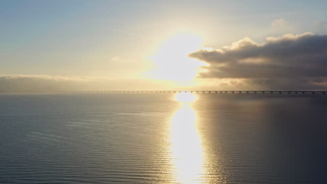 Great Belt Bridge With Aircraft Contrail Above At Sunrise
