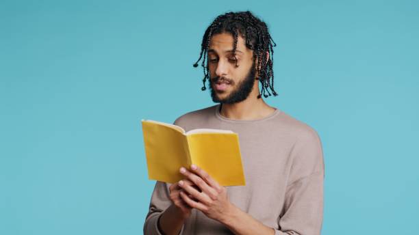 istock Person narrating literature novel, doing critique essay, studio background 2015307013
