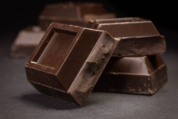 istock Broken chocolate. Chocolate pieces. Chocolate pieces on dark background. 2015313564