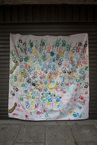Colorful hand prints on white fabric