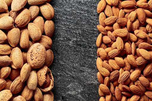 Almonds on a stone background. Top view with copy space.