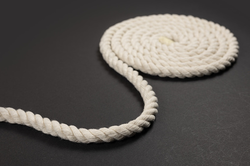 Coiled rope over a dark background.