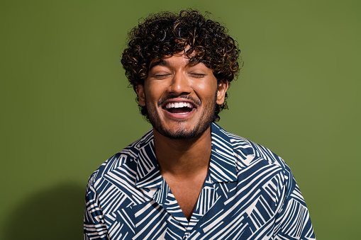 Closeup photo of young funny guy laughing mexican student in shirt enjoying comic joke at stand up show isolated on khaki color background.