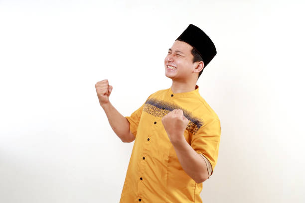 istock Successful happy muslim man screaming shouting and shows winning victory gesture over white background 2015320199