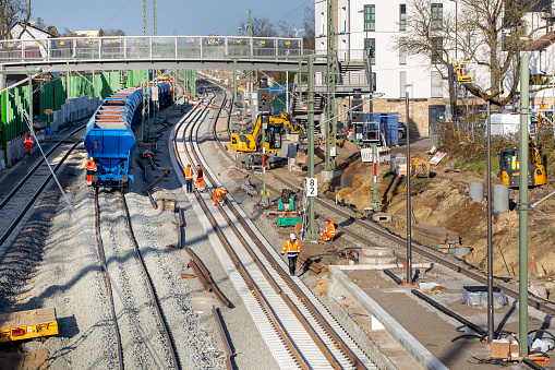 Frankfurt, Germany - February 05, 2024: Railroad construction site in Frankfurt-Eschersheim - track workers laying rail tracks and building a railroad station platform