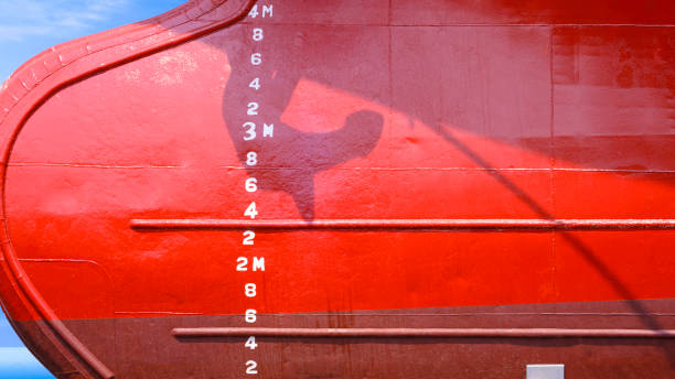 Draft mark numbers on red hull surface of oil tanker ship after Renovation work