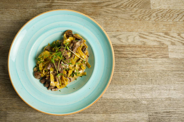 Pork with pasta and mushroom sauce