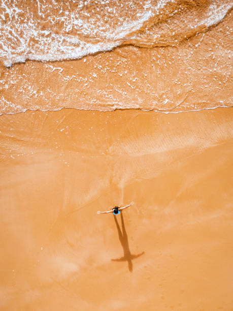 istock drone view on  woman doing yoga at beach 2015369881
