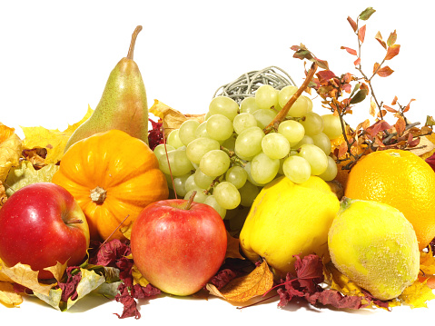 Assortment of autumn fruit. Pear, peach, grapes and pumpkin