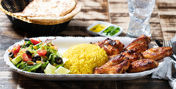 2/3rd angle of Chicken Wings, Saffron Rice, Chopped Salad, Flatbread, Olive Oil