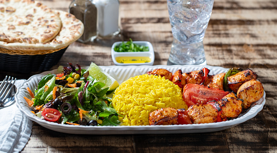 2/3rd angle of Chicken Shish Kebab, Saffron Rice, Chopped Salad, Flatbread, olive oil