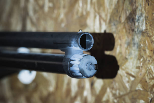 Closeup shotgun aiming to shooting target ahead.