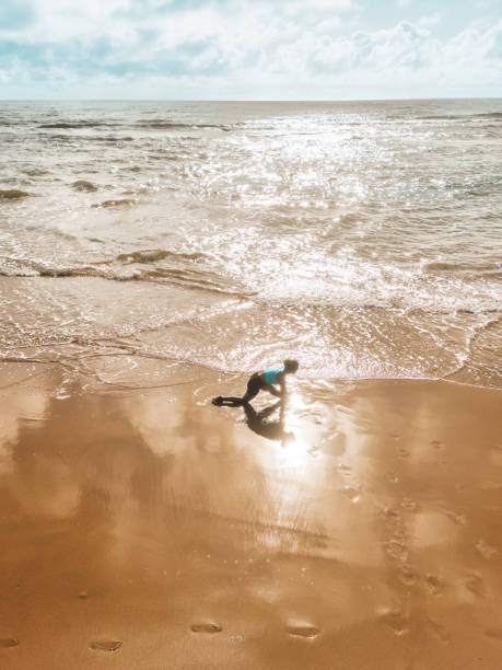 istock drone view on  woman doing yoga at beach 2015386670