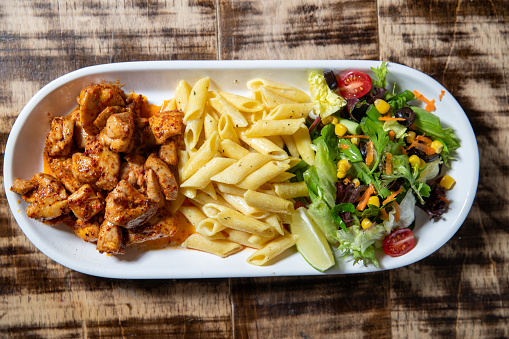 Overhead image of Spicy Chicken, pasta and Salad