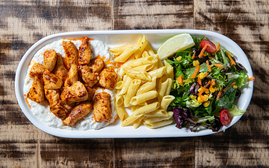 Overhead image of Spicy Chicken over Yogurt, Pasta and Salad