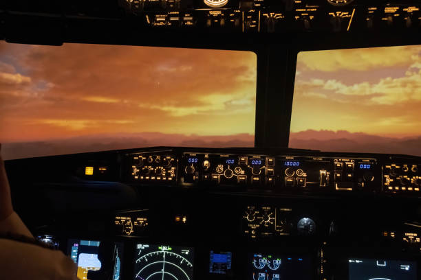 Dark cockpit alive with warm hues of sunrise during flight. Professional captain skillful navigation and serenity of sunrise flight