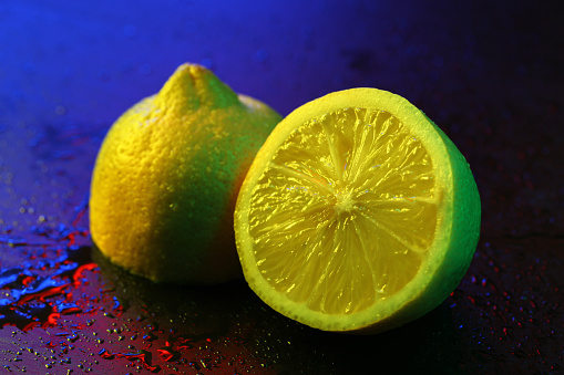 Wet Lemon in abstract lighting.