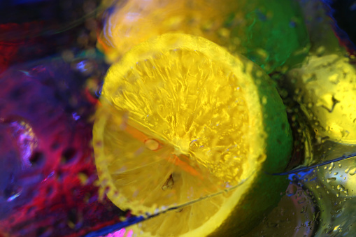 Wet Lemon in abstract lighting.