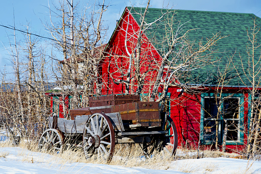 Como, Colorado, USA - February 12, 2024: An old wooden wagon sits in the yard of a home in the historic town of Como, a former coal mining and railway center during the late 1800s.