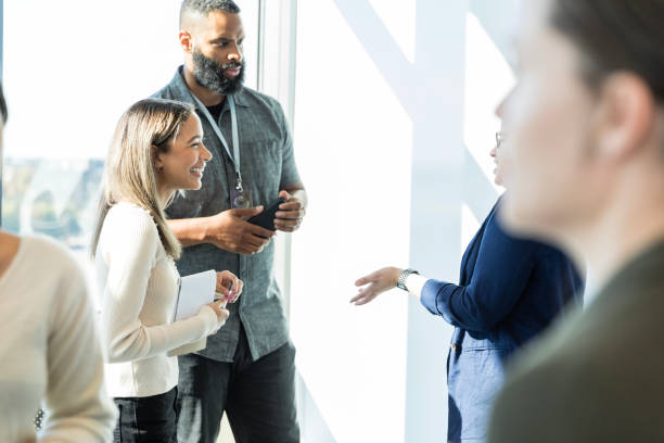 istock Diverse group of marketing professionals talk in groups 2015414473