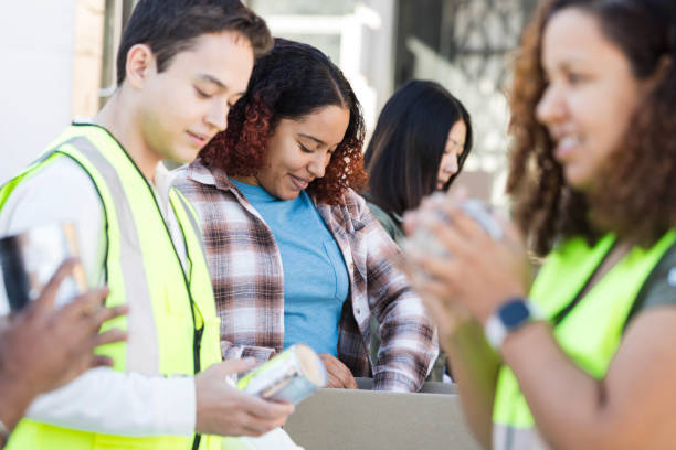 istock Diverse volunteers organize canned food into boxes 2015438607