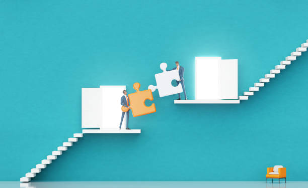 istock Successful business people working together with puzzle pieces. Business environment concept with stairs, representing career, growth, success, solution and achievement. 2015446029