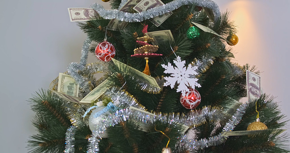 Christmas artificial Christmas tree decorated with balloons, glitter and money. High quality photo