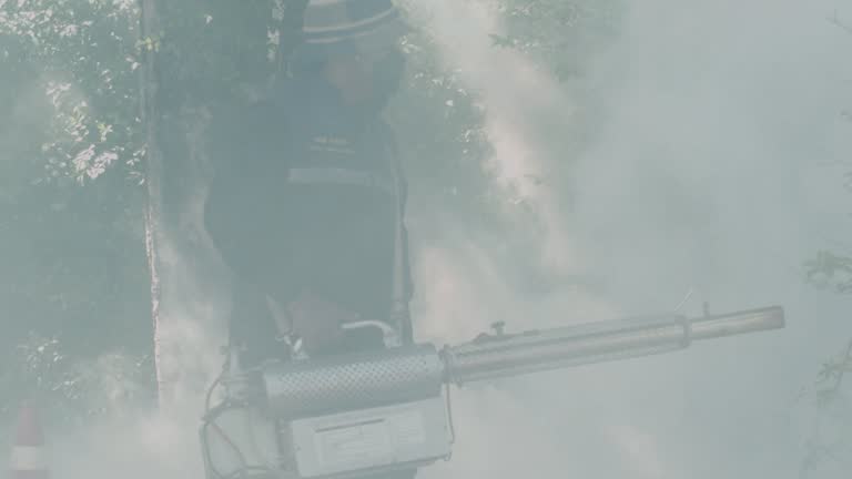 Officer Anti-Mosquito Spraying Smoke to Kill and Clear Up Mosquito to protect Malaria with Machine in the Village in Thailand.