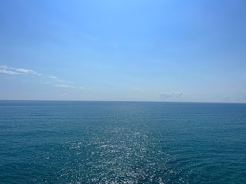 A stitched panorama of a vibrant blue ocean.