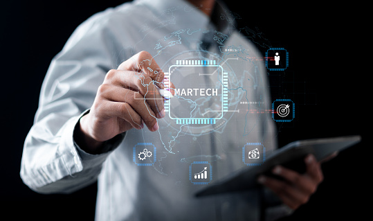 Martech marketing technology concept. Businessman touching network connection on online marketing system for digital market commerce online sale. Marketing automation and digital advertising.