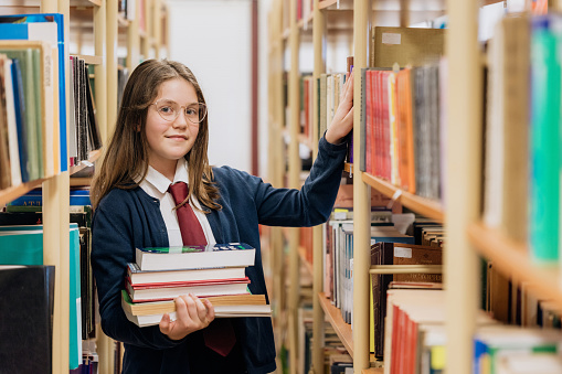 Middle school student choosing a book from the school library