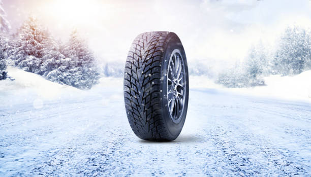 istock Winter tire on road covered with snow 2015539856