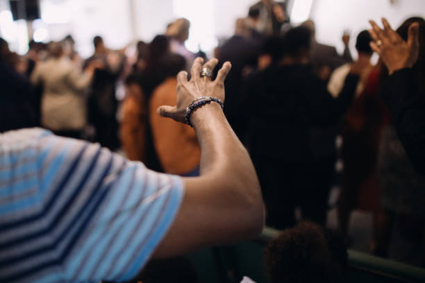 An African American church in the United States participates in a prayer and worship service.