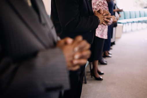 An African American church in the United States participates in a prayer and worship service.
