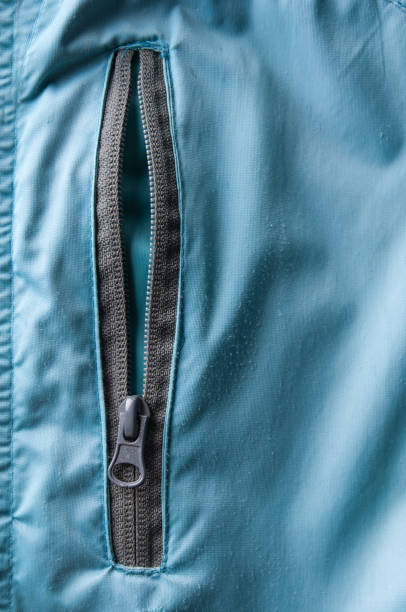 A concept showing a flat blue fabric item joined with a parting metal zipper on an isolated white background - 3D render