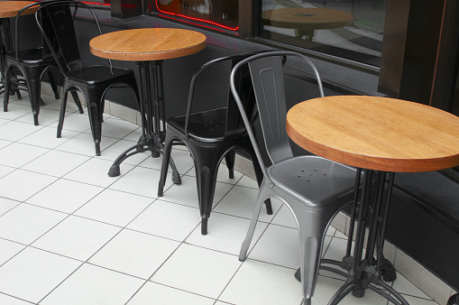 Interior cafe with plastic chairs and round tables