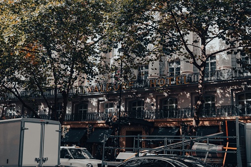 London, United Kingdom – October 19, 2022: Van parked in front of a multi-storey building adorned with balconies, surrounded by cars