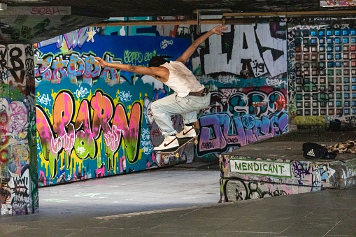 London, United Kingdom – August 22, 2021: Skateboarder performing trick in open air space