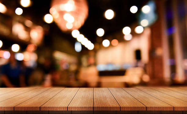 istock Empty wooden table top with lights bokeh on blur restaurant background. 2015617879