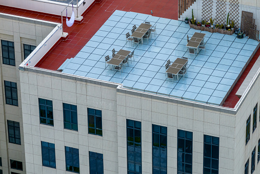 Tables and chairs with a bird's-eye view of the rooftop