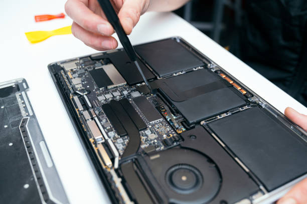 istock Unrecognizable Person Repairing Open Laptop's Internal Components 2015645812