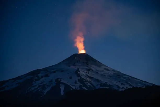Close-up shot of the active Villarrica volcano at night with a sky full of stars near Pucón in Chile
