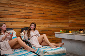 Friends in the sauna: women's relaxation with tea and smiles
