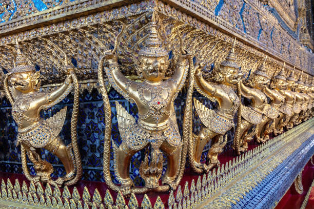 Line of Garuda statues adorning a temple wall in the Grand Palace, Bangkok, Thailand.