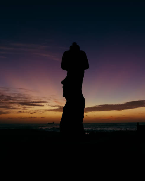 Rapa Nui Moai at Sunset with sunshine from behind Atardecer en Rapa Nui. Moais en contraste con la puesta de sol. statue moai stock pictures, royalty-free photos & images