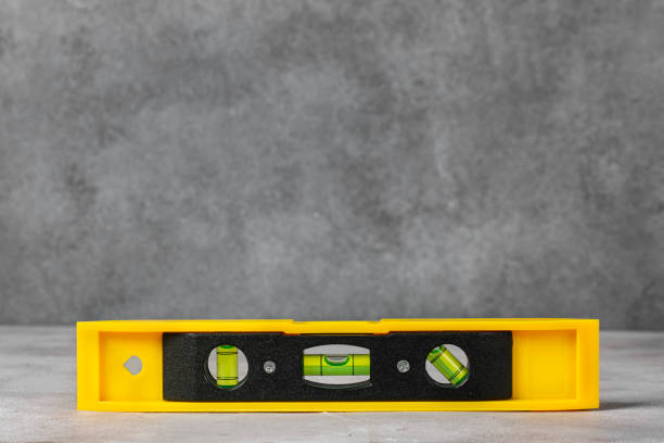 istock The yellow building level lies on a flat surface. 2015682239