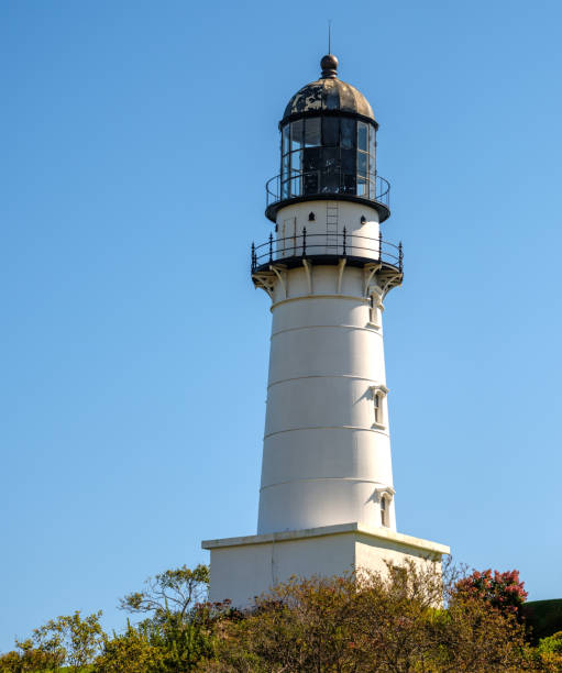 istock Low angle view of a New England Lighthouse against a  clear blue sky 2015701111