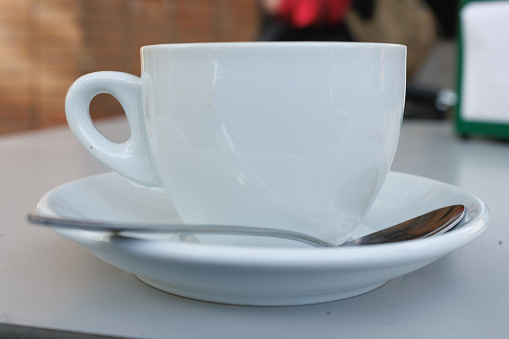 Close-up of cup of coffee with milk on the terrace of a bar in Alicante, Spain